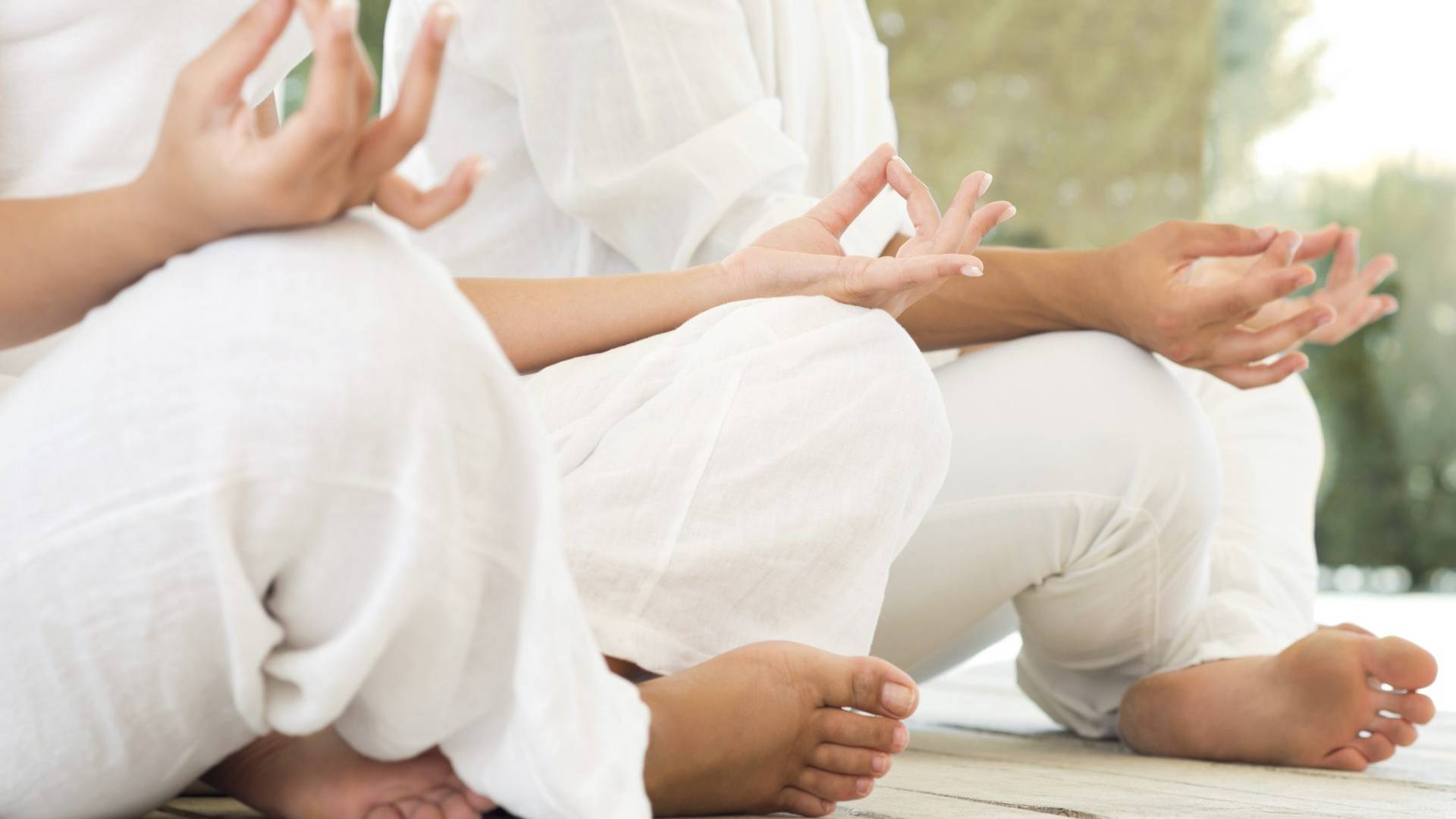 two people sitting in lotus position
