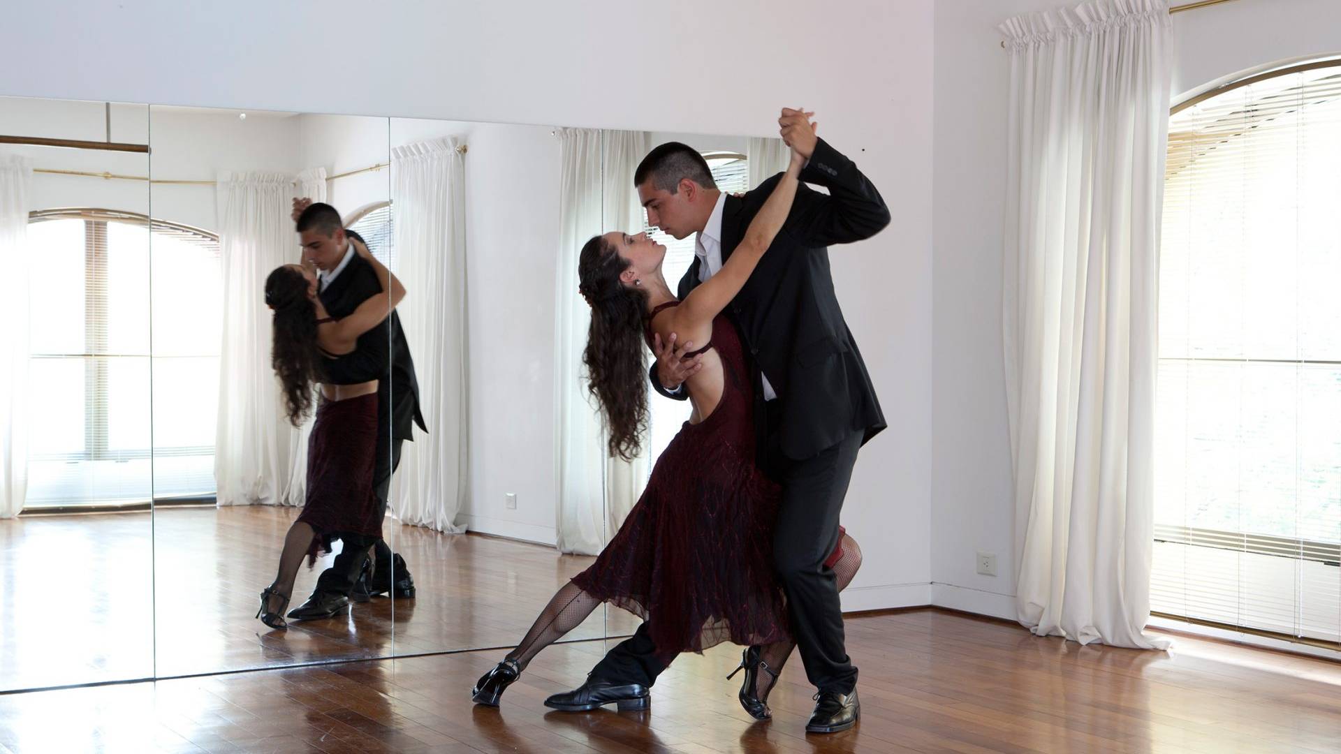 two couples dance the tango