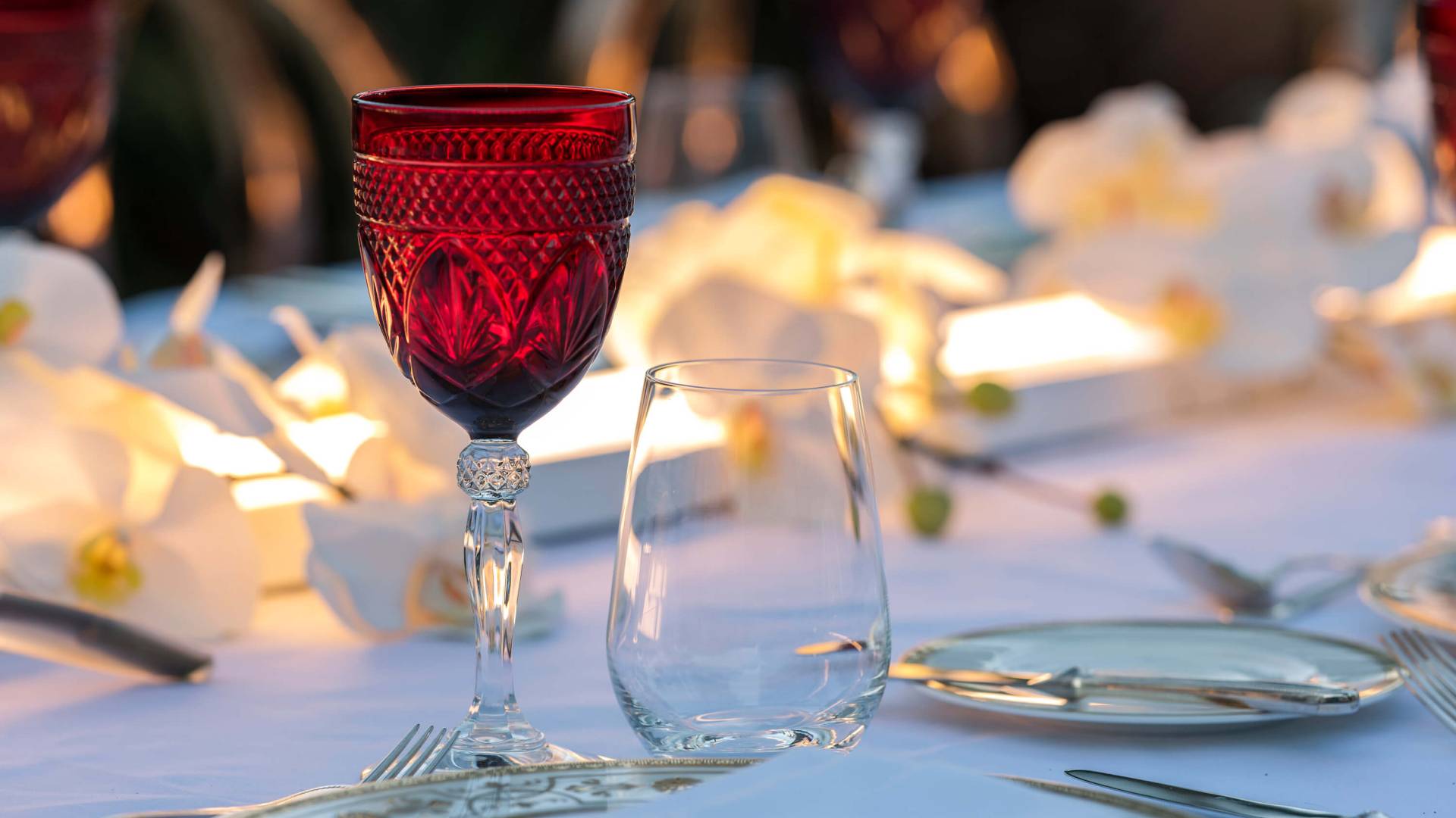 wine glass on wedding reception table with flowers