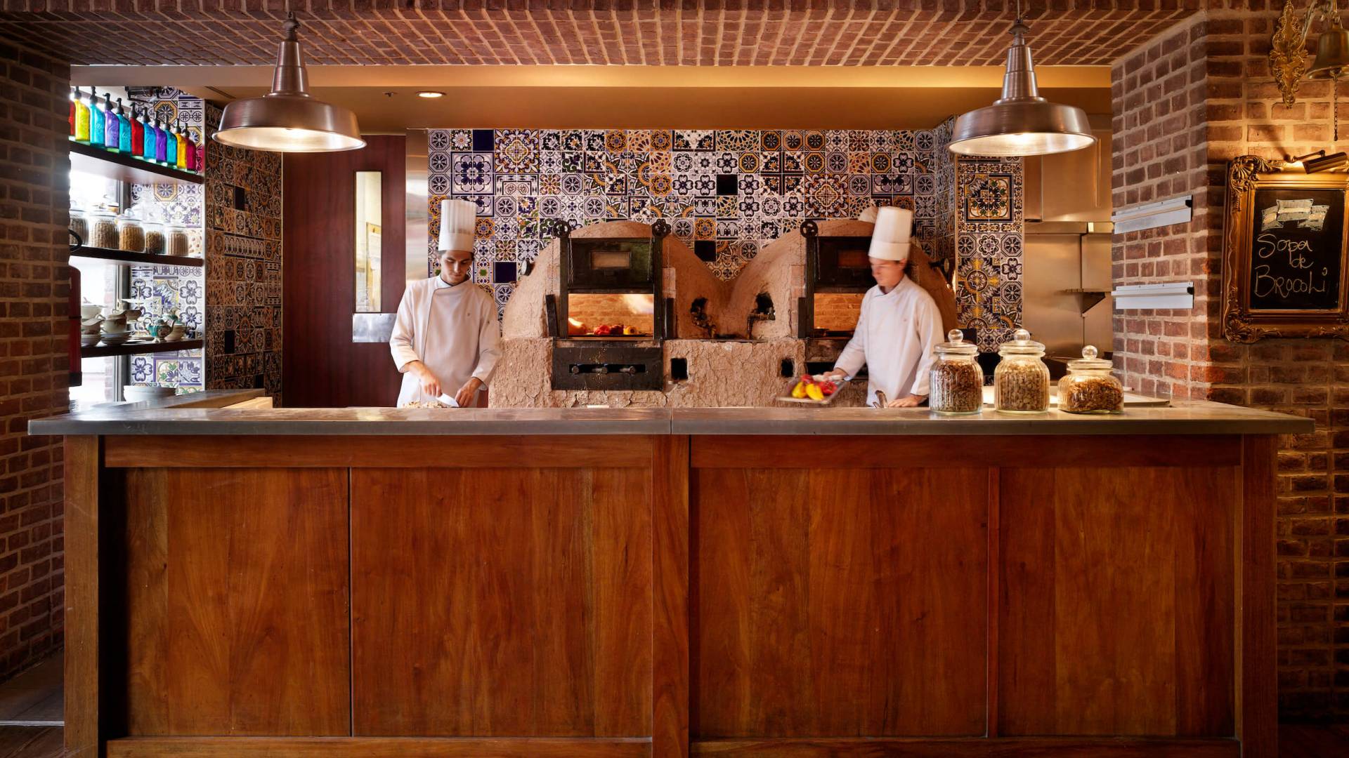 two chefs cook in kitchen