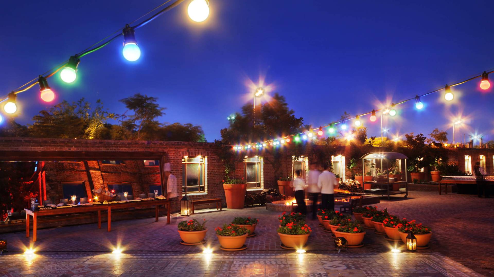 patio lit up by multicolored strings of lights