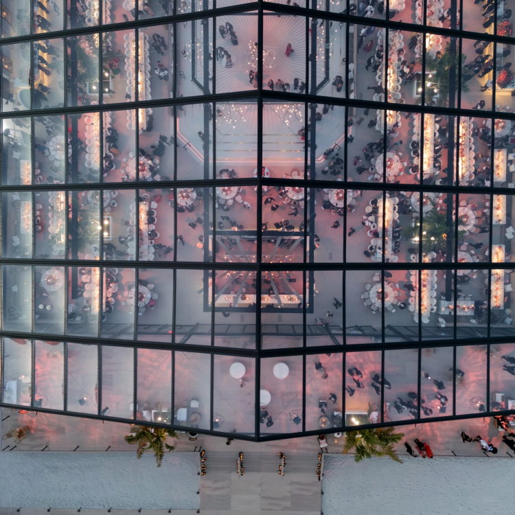 Aerial of wedding reception in a building with a glass cieling