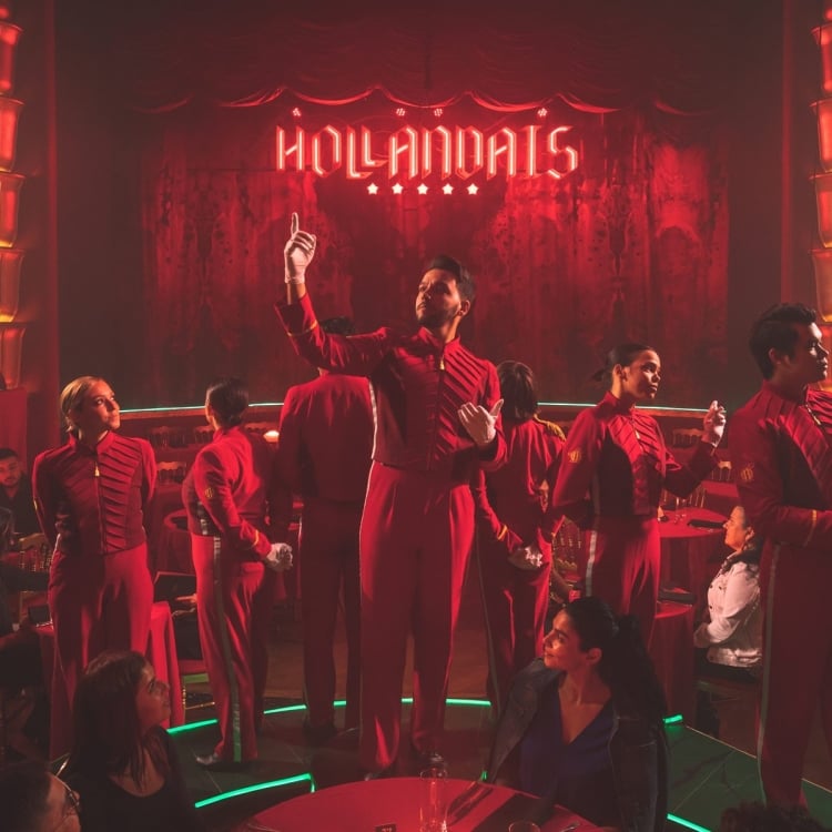 faena theater performers stand in front of stage all wearing red
