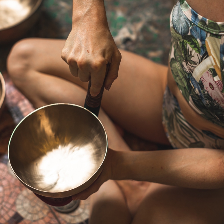 woman holding singing bowl