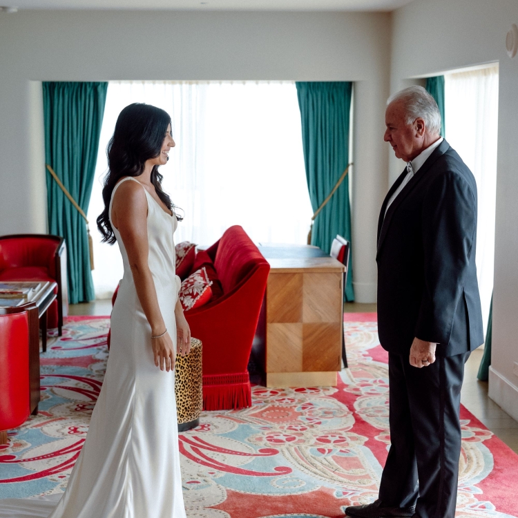 Father of the bride seeing his daughter in her wedding attire