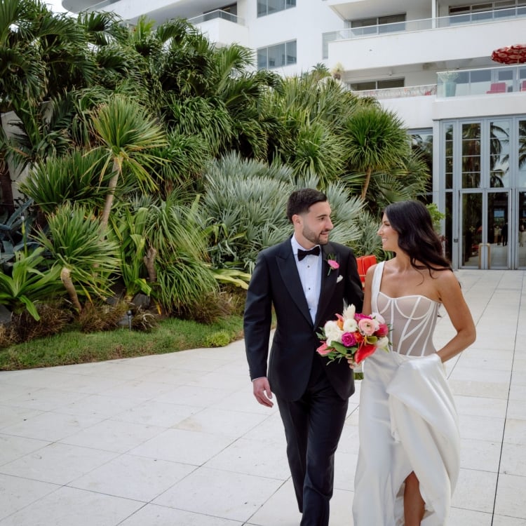 Bride and groom walking on the sidewalk