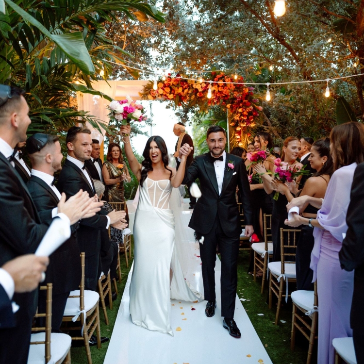 Bride and groom after wedding ceremony walking down the aisle