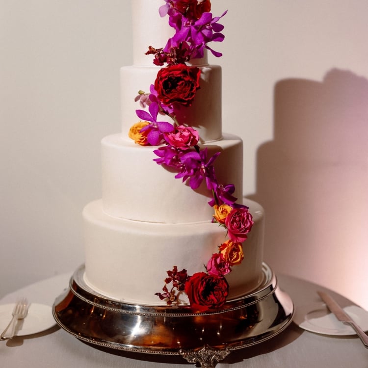 four tier white wedding cake with pink flowers