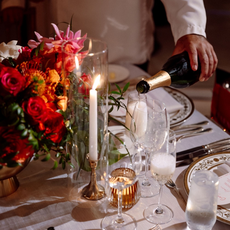 a man pouring wine into a cup