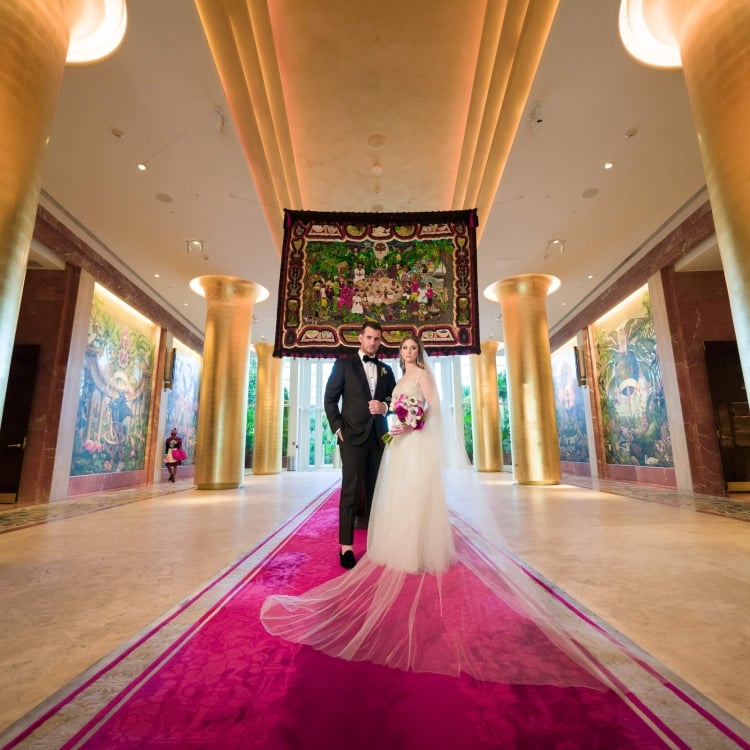 bride and groom stand in Faena entrance