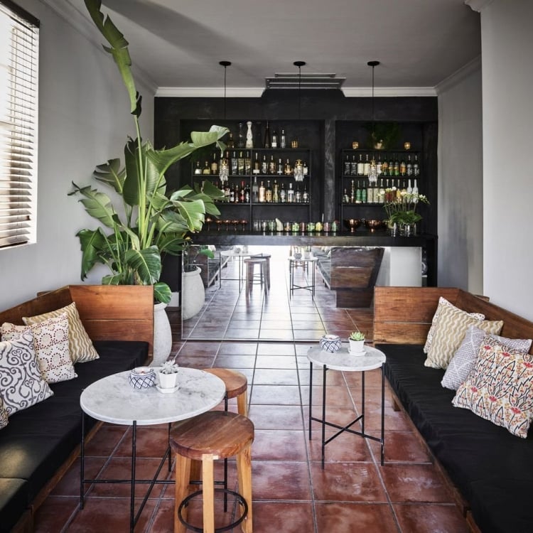 indoor bench seating with bar in the background