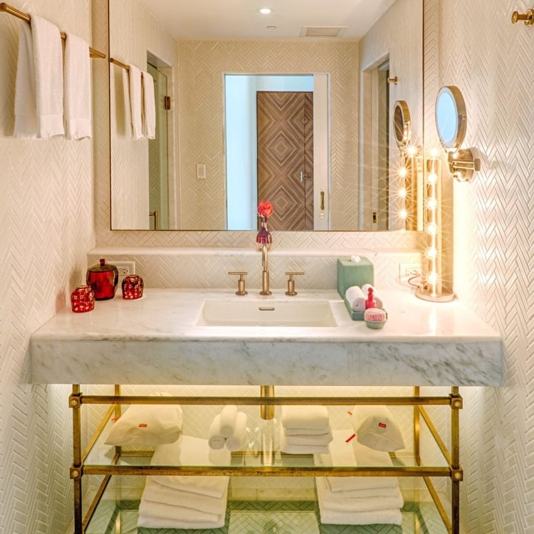 hotel bathroom with large mirror and sink