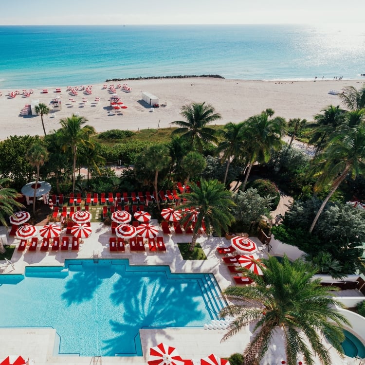 Aerial view of hotel pool on the edge of beach