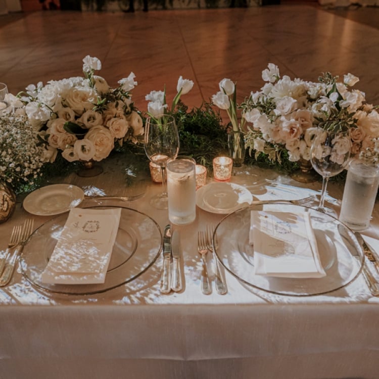 Newly wed diner table with lots of flowers.