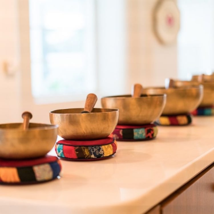 gold singing bowls sit in a row