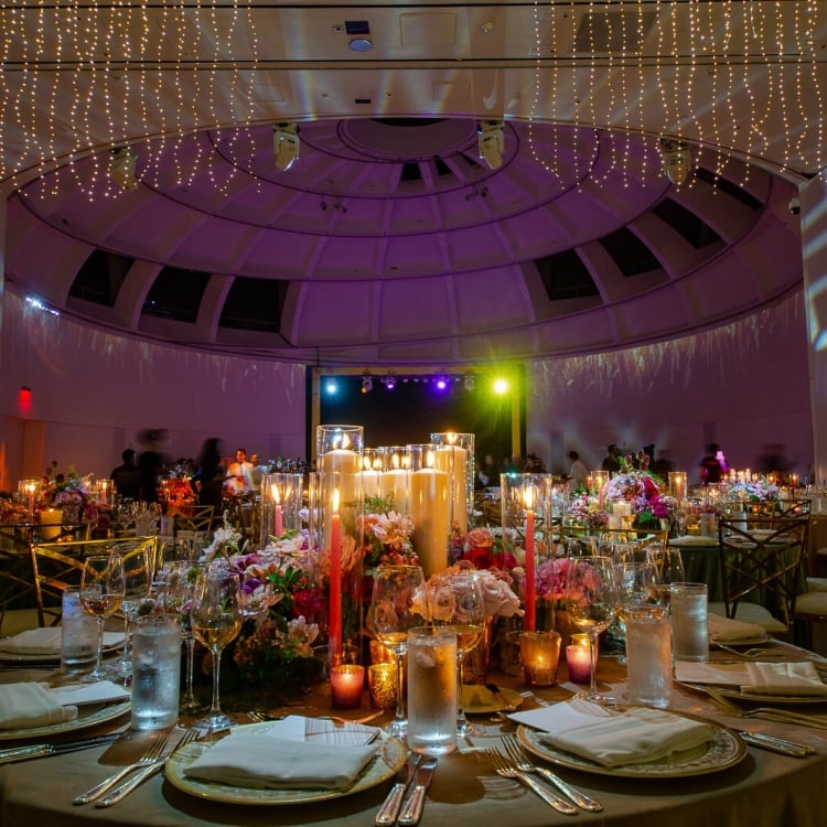 low lit table placement with candles and purple backlit