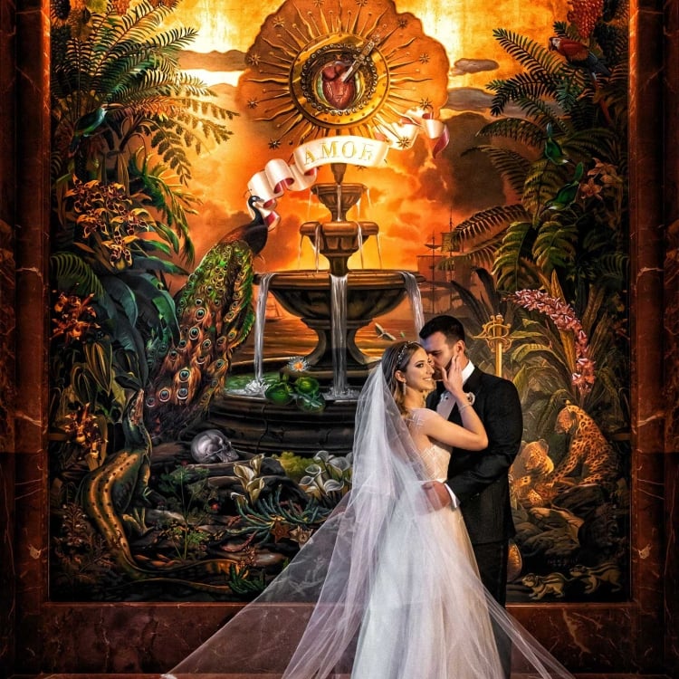 Jaclyn and Michael posing in front of some artwork