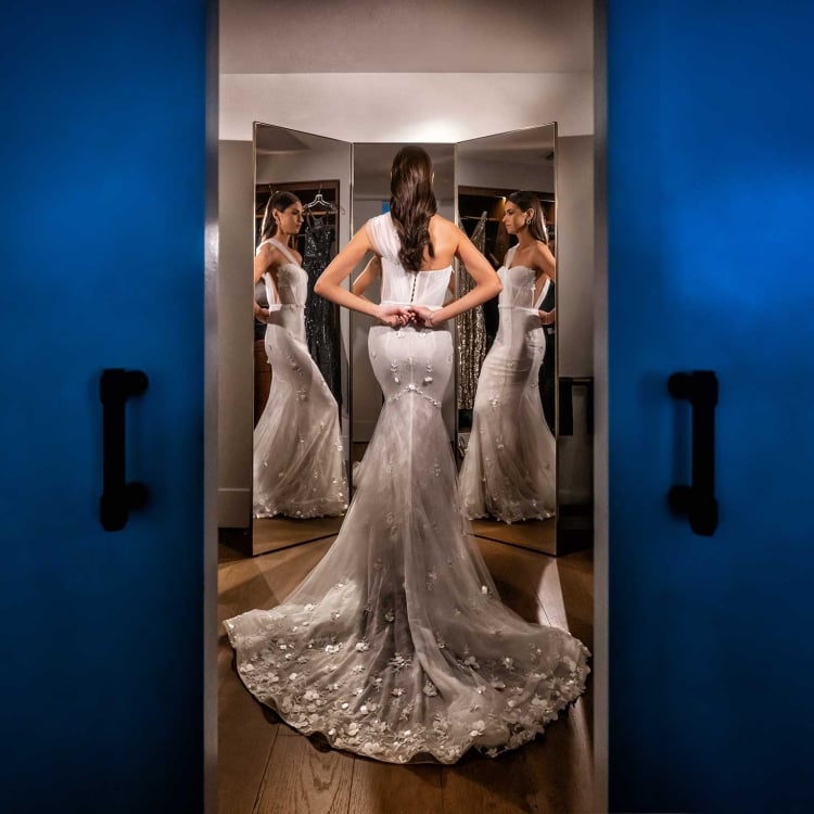 Bride putting on her dress