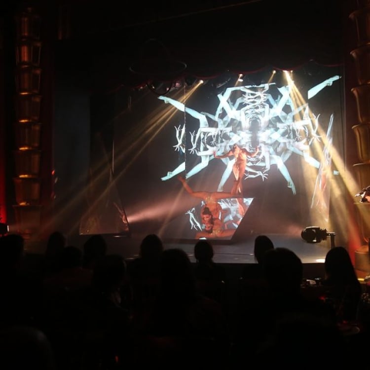 samsara cabaret performers create geometric pattern with their legs and arms