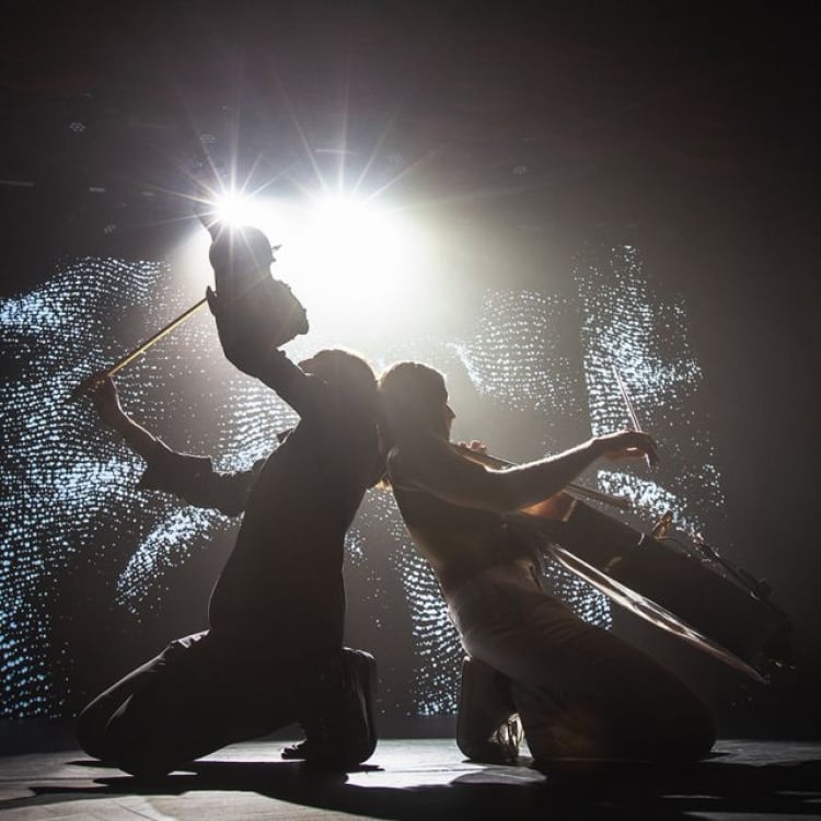 two performers silhouettes while playing instruments