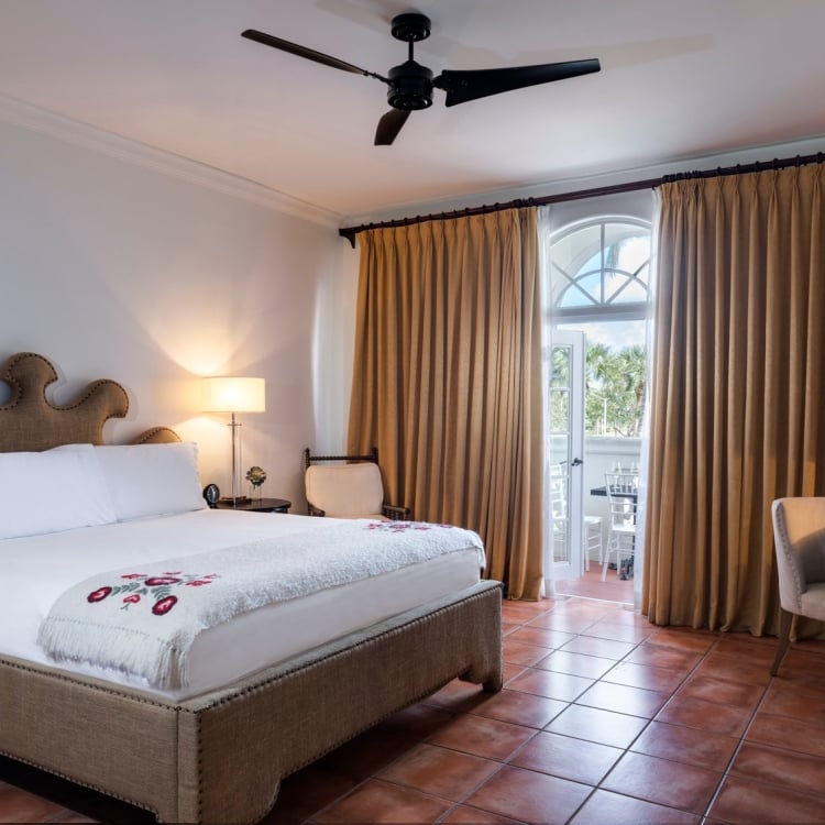 hotel bedroom with large bed and balcony
