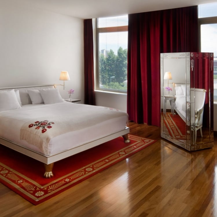 bed in hotel room with large windows