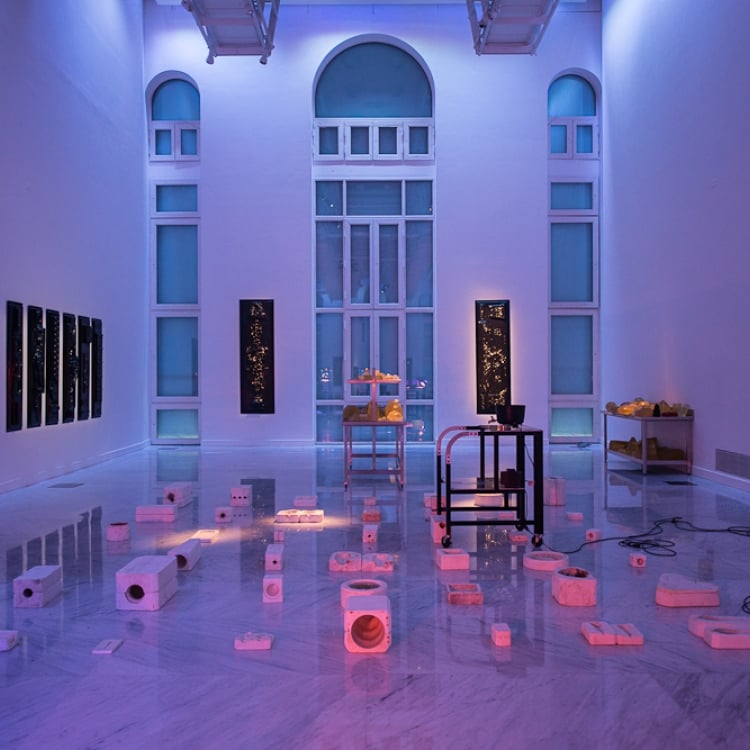 art installation with blocks on the floor in a grid pattern