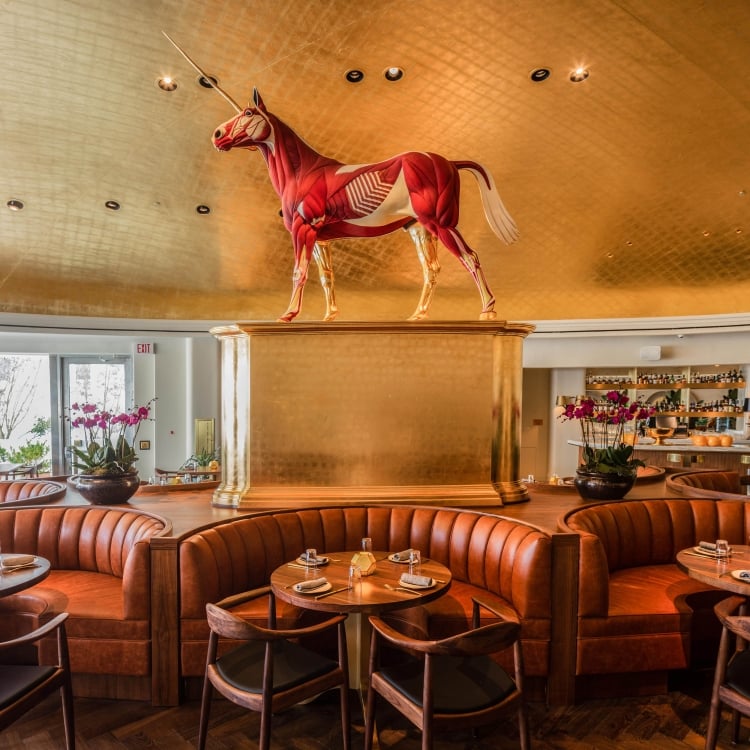 unicorn statue on a riser over rounded bench seating
