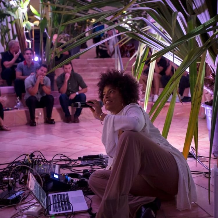 Woman holding a microphone at Faena Art Basel