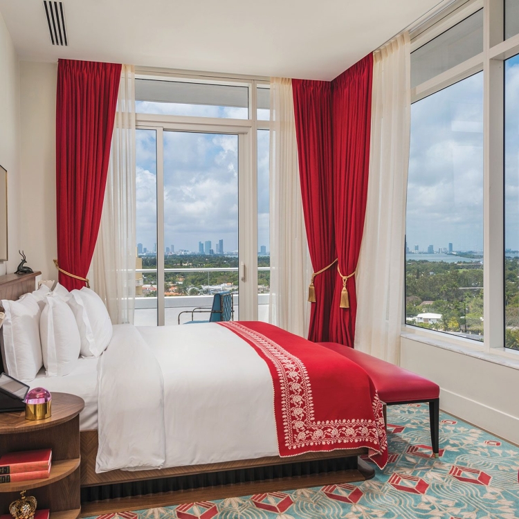 bedroom in hotel with large windows on two sides
