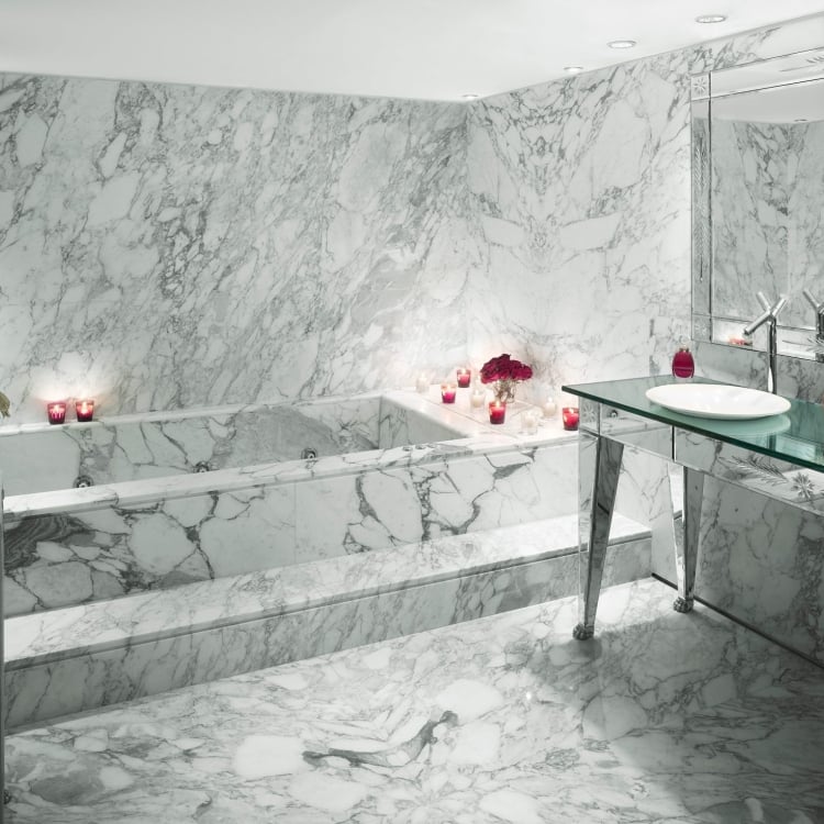 marble bathtub and sink area in hotel suite