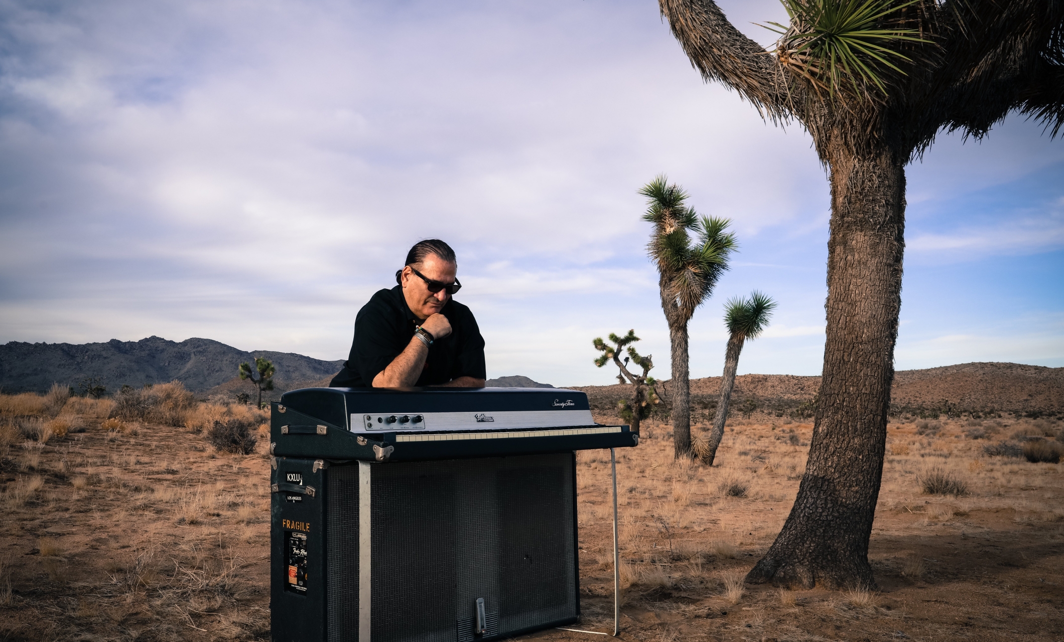 David Garfield leaning on a keyboard in the desert