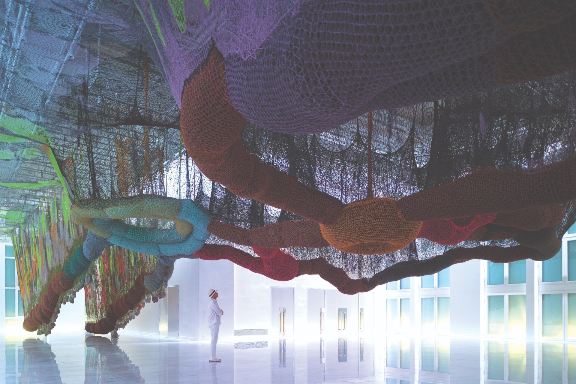 Alan Faena looking up at an art exhibit