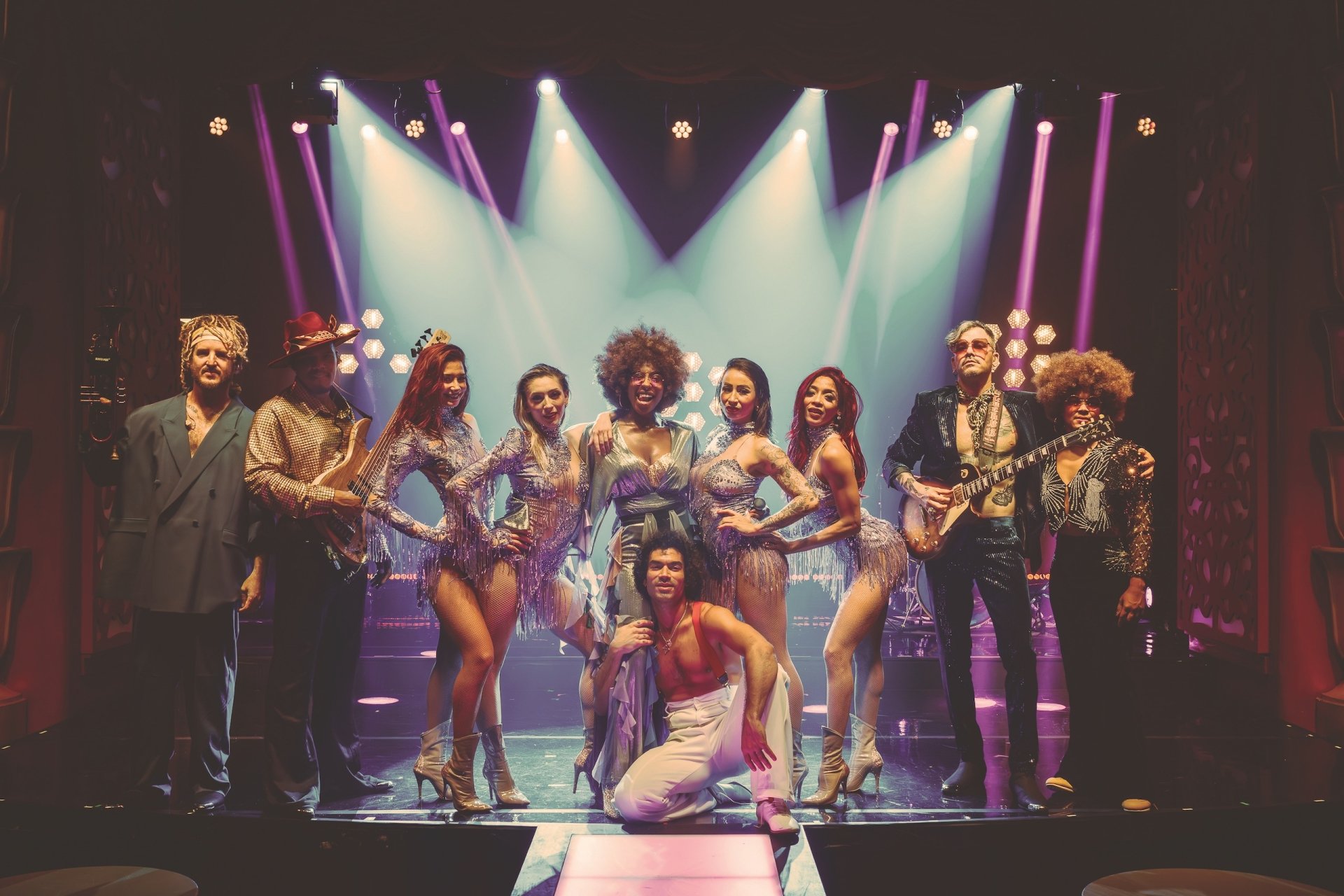 A group of dancers posing for a photo after a show