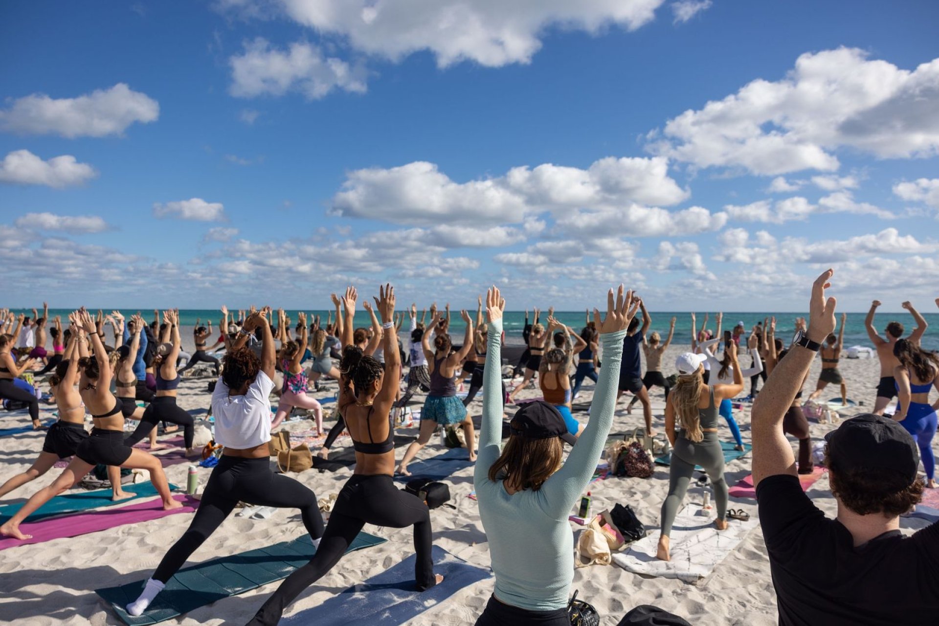 Group of people doing pilates on the beach