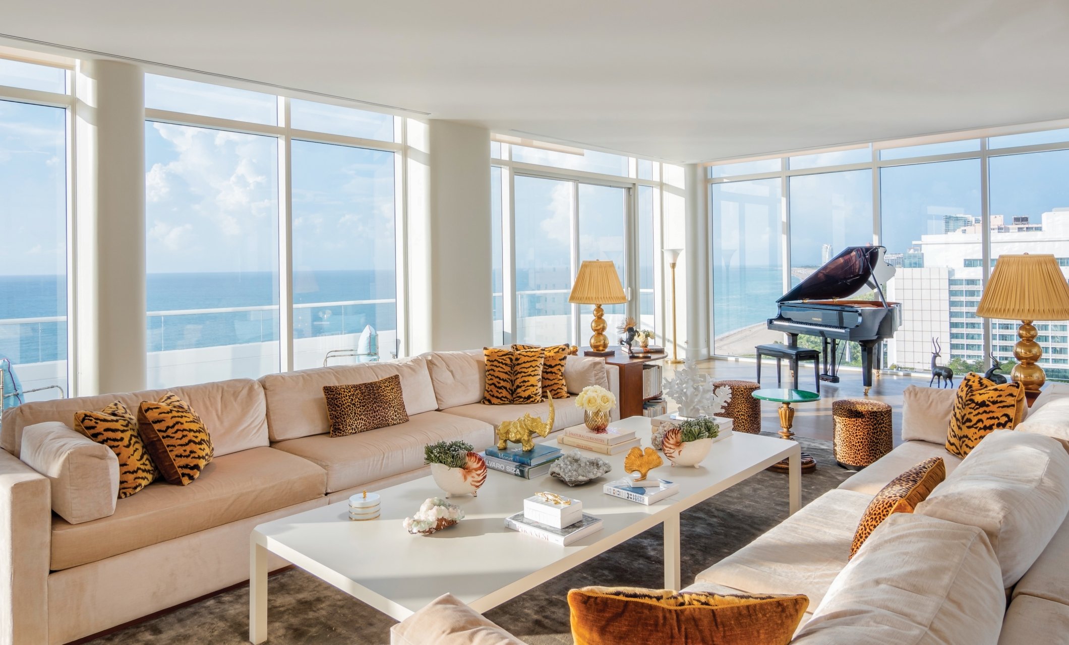 large hotel penthouse with living space and grand piano in the distance