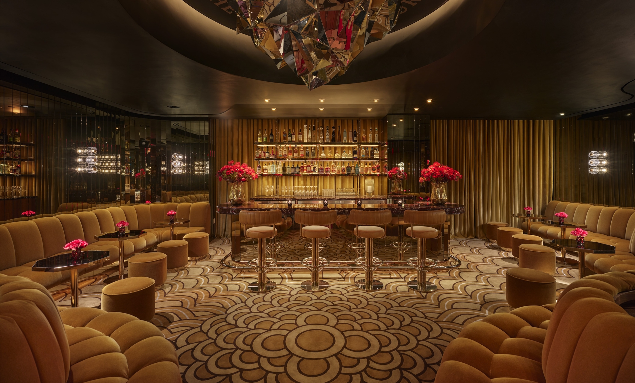 A bar with ample booth seating and gold adornments