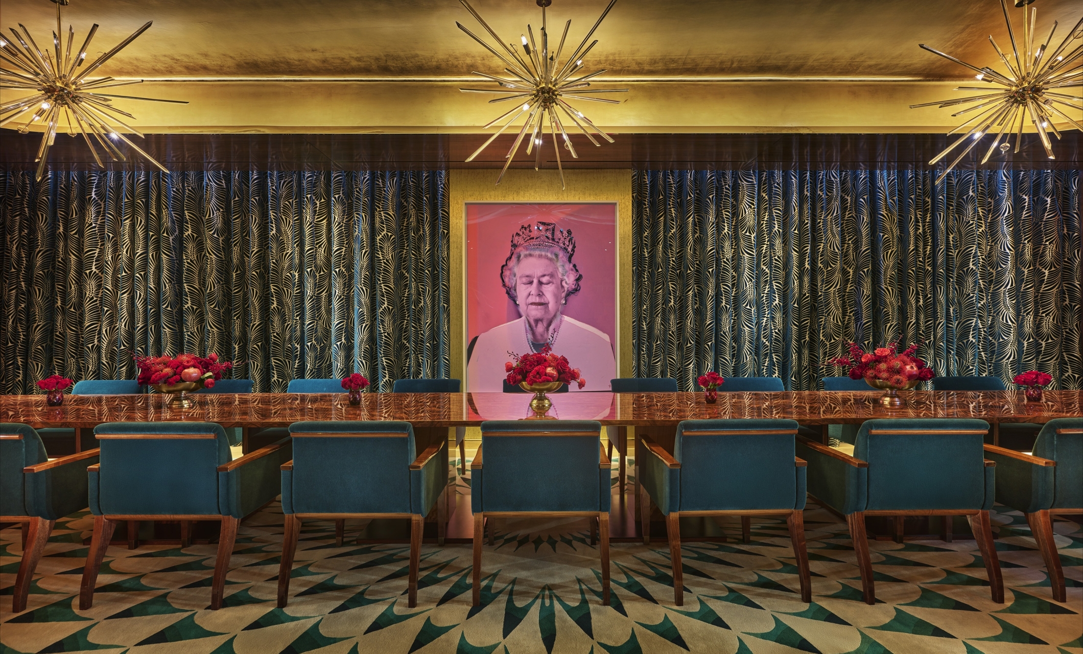 An eclectic private dining room with a long table and a pop art painting of Queen Elizabeth