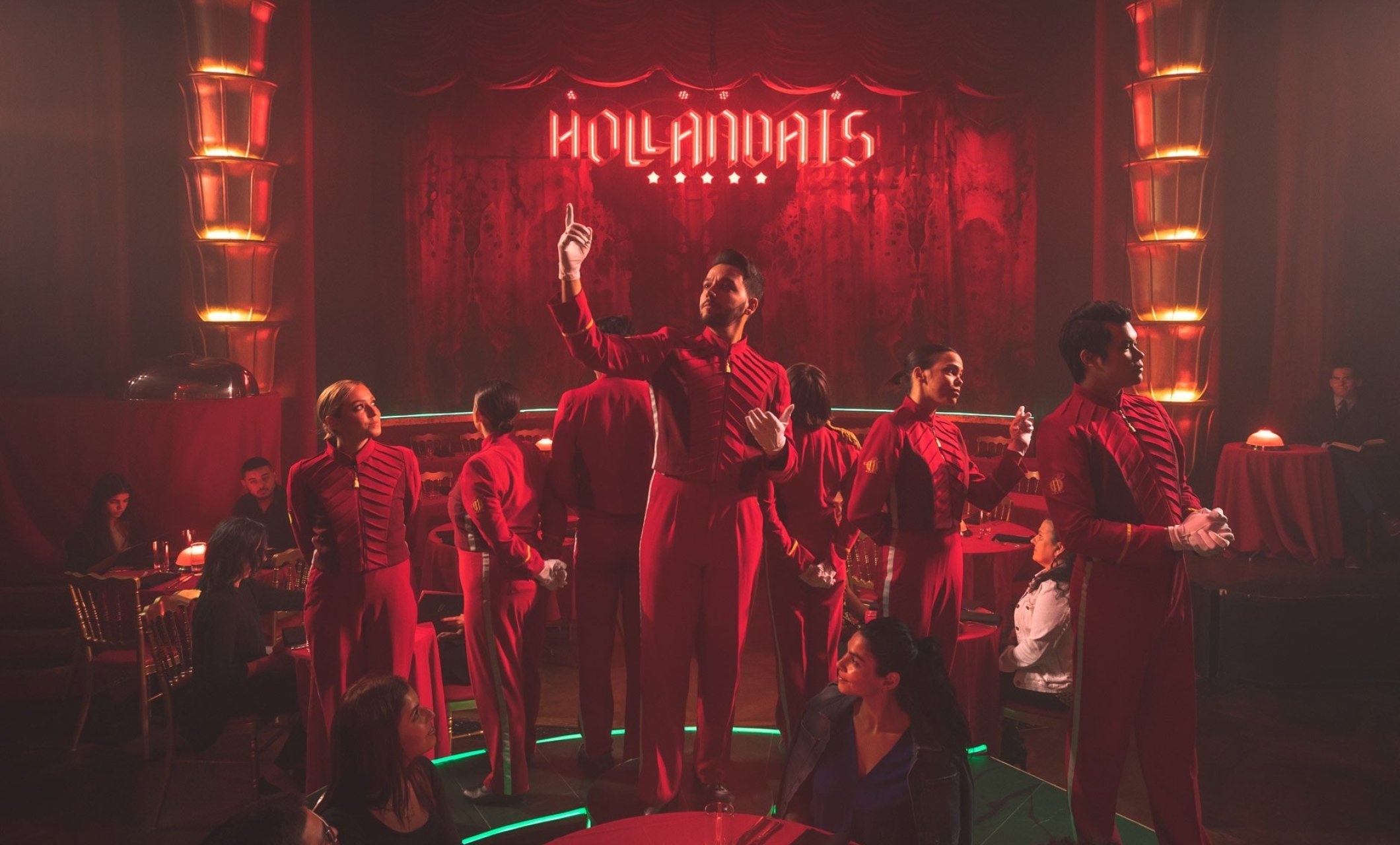 faena theater performers stand in front of stage all wearing red