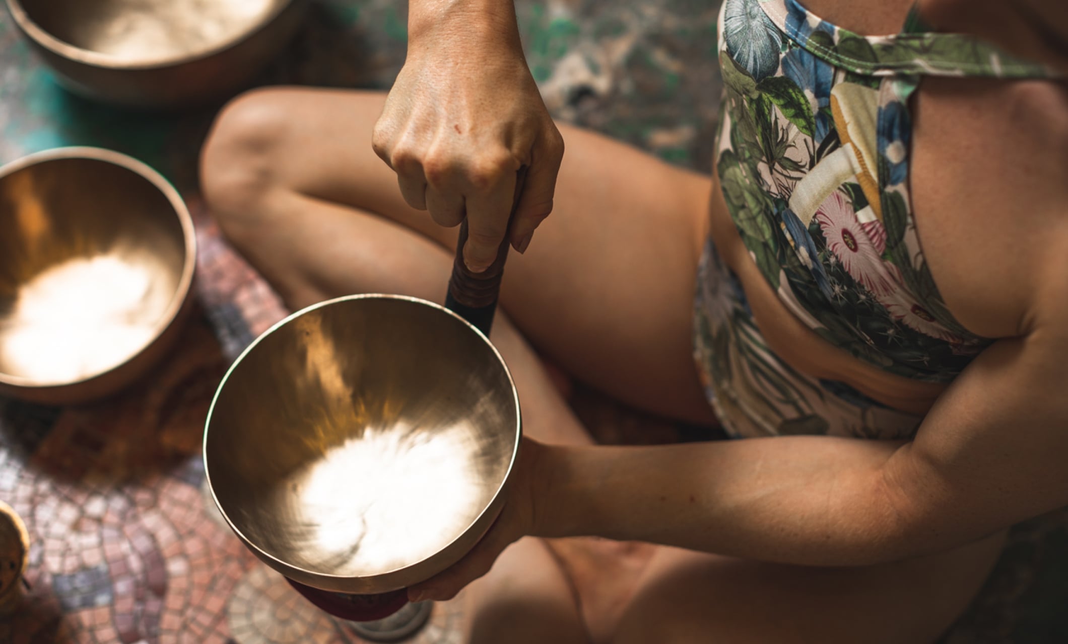 a woman holding a tibetan singing bowl
