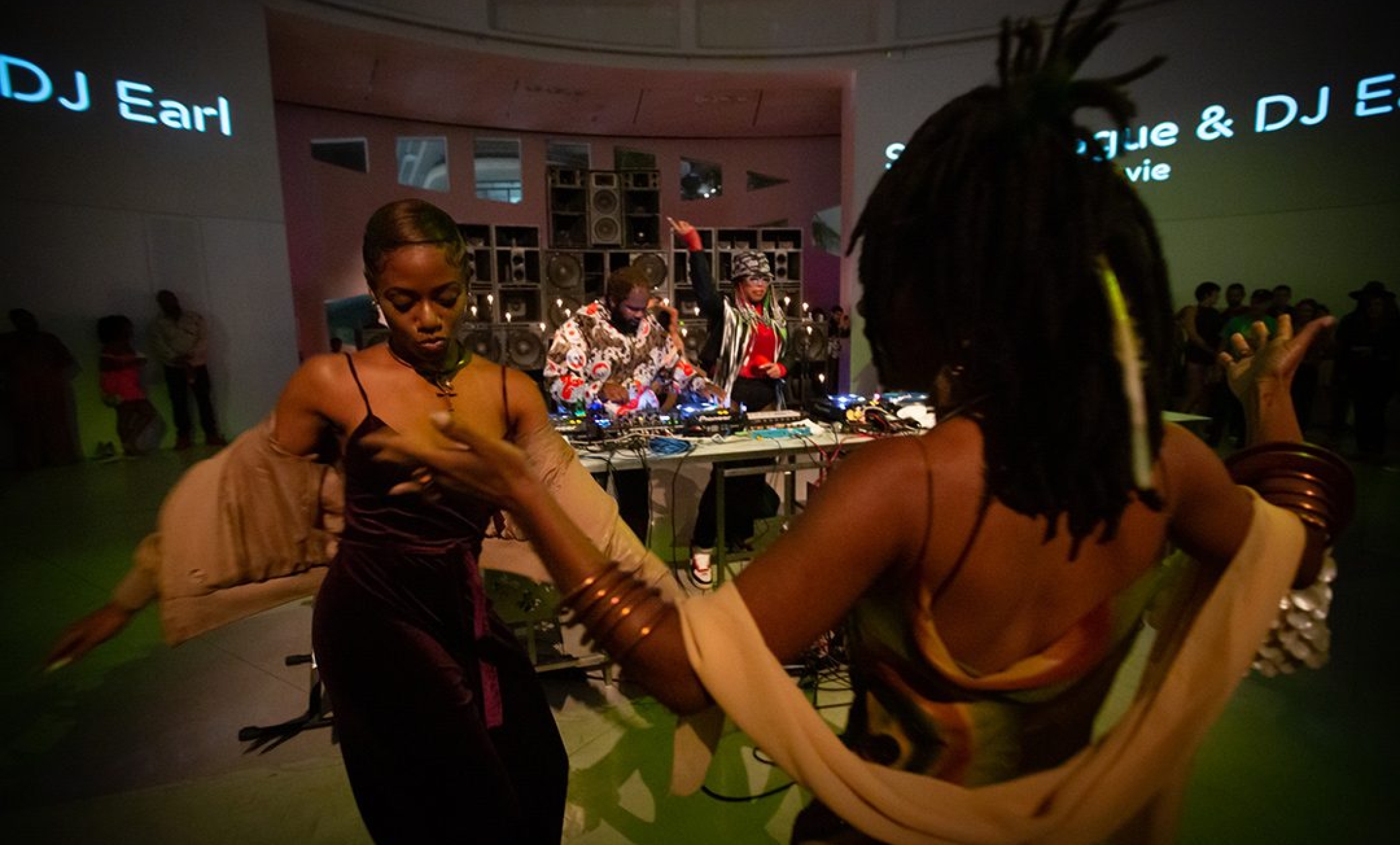 group of people dance in front of DJ booth