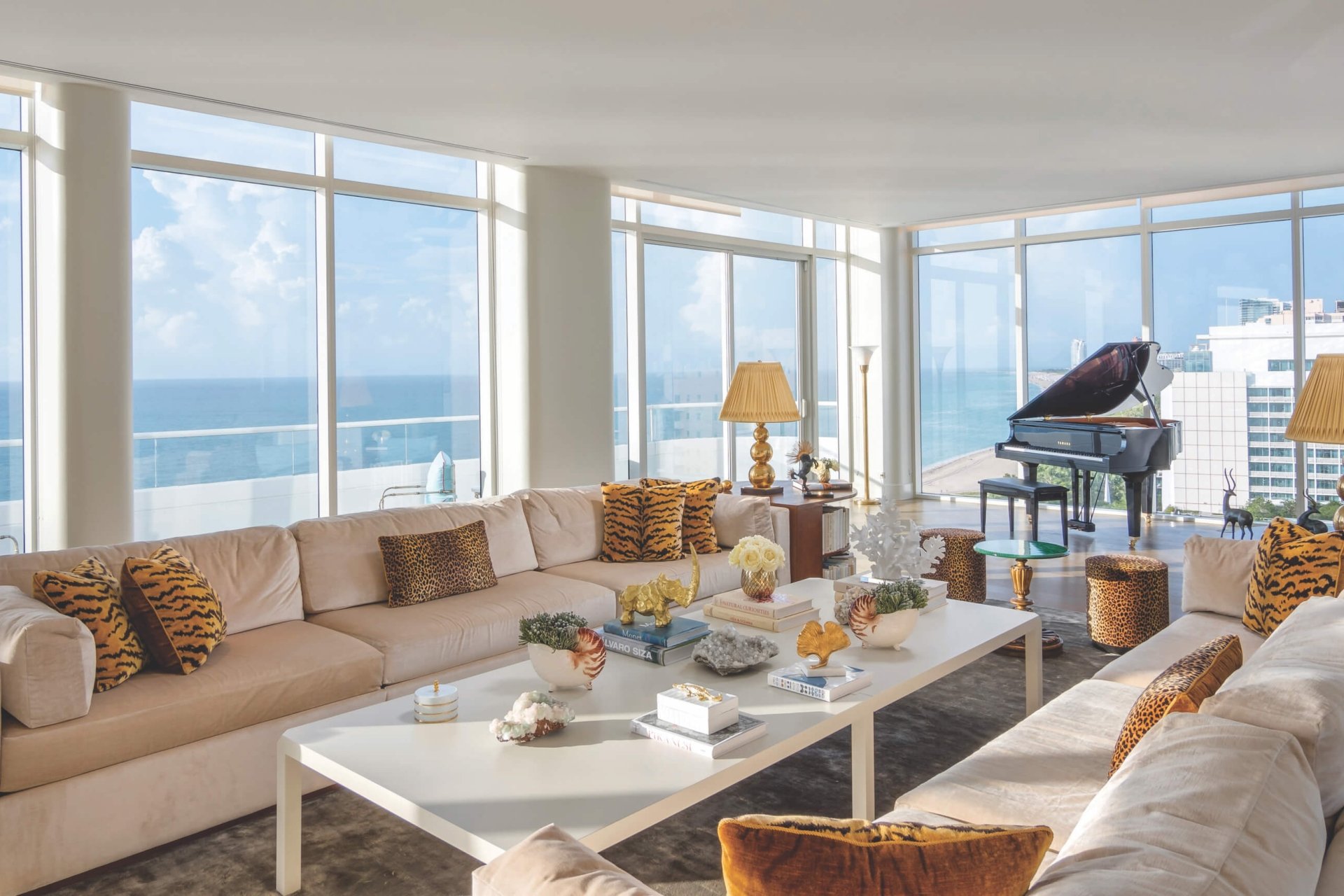 living room with a grand piano and floor to ceiling windows