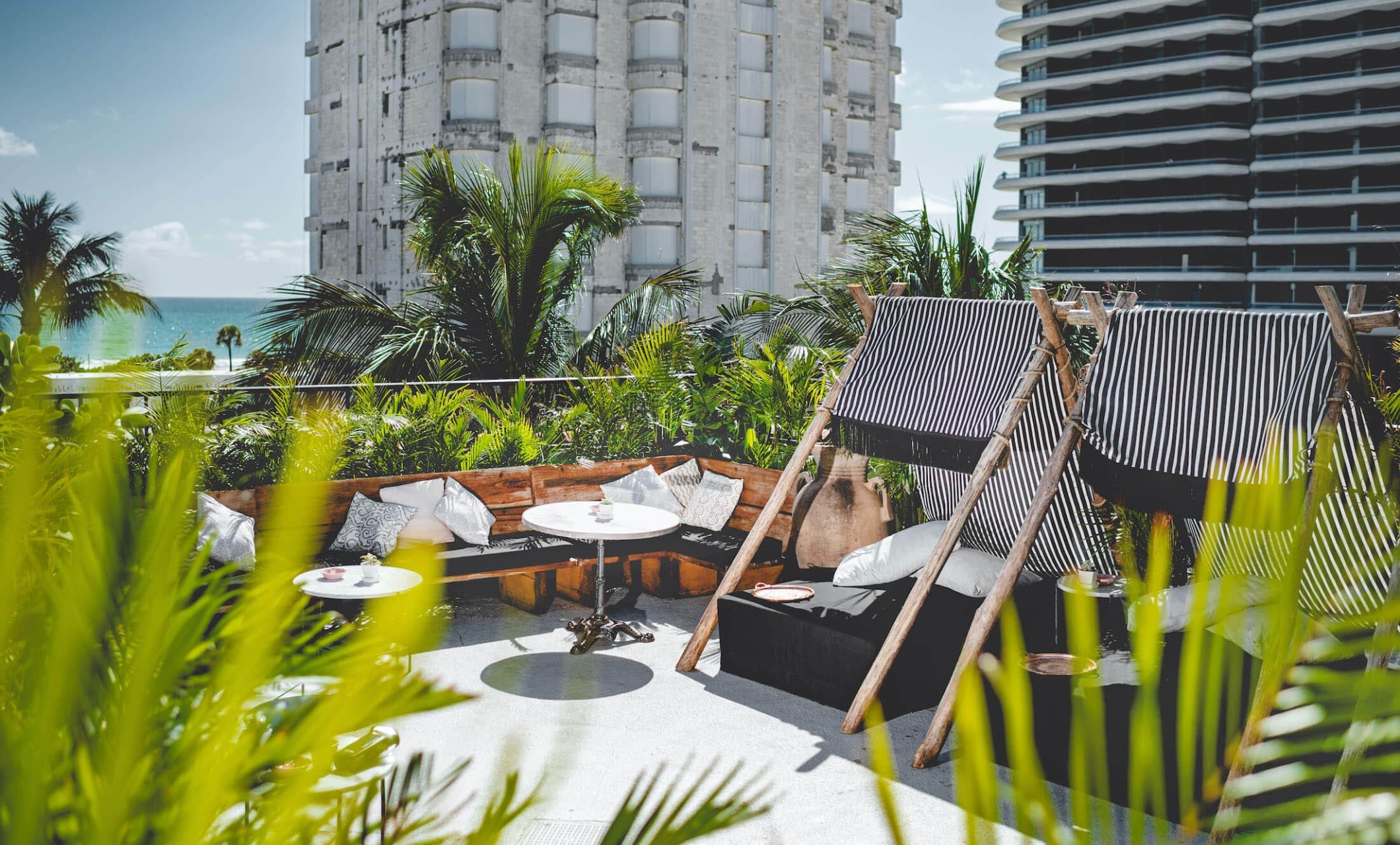 rooftop seating area with greenery framing space