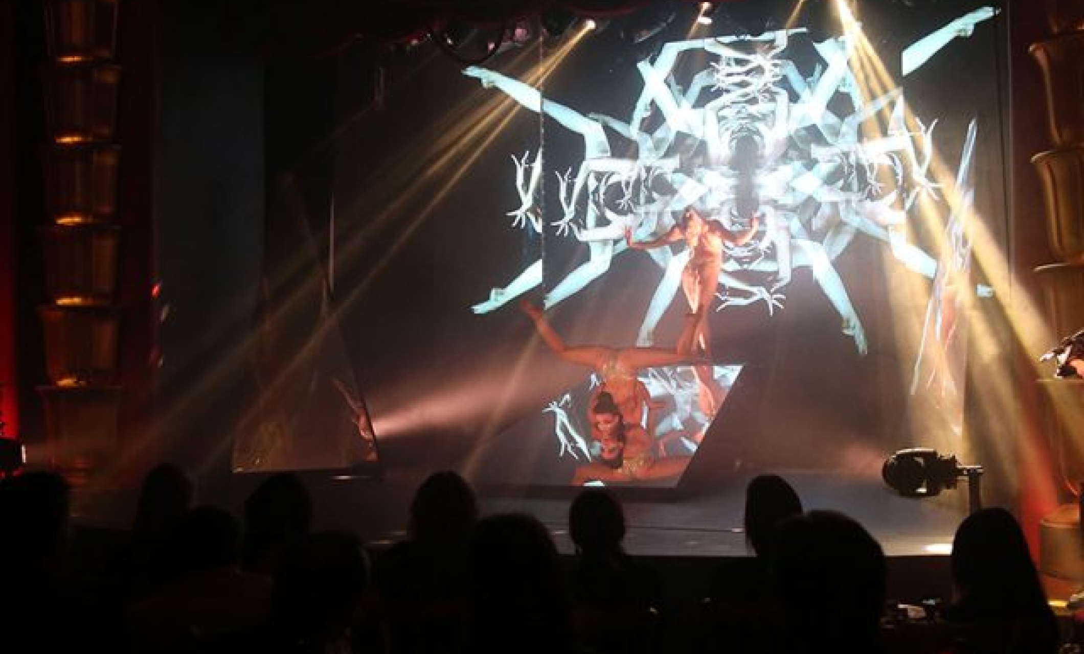 samsara cabaret performers create geometric pattern with their legs and arms