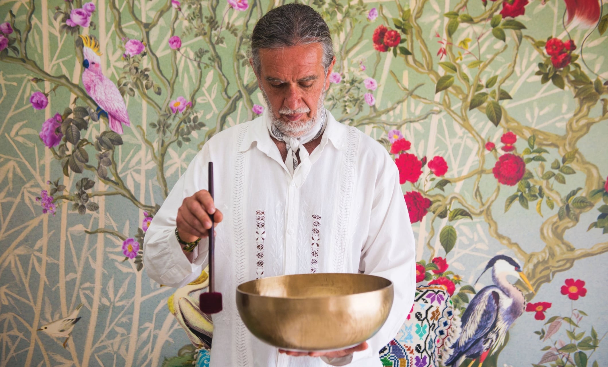 a man holding a tibetan bowl