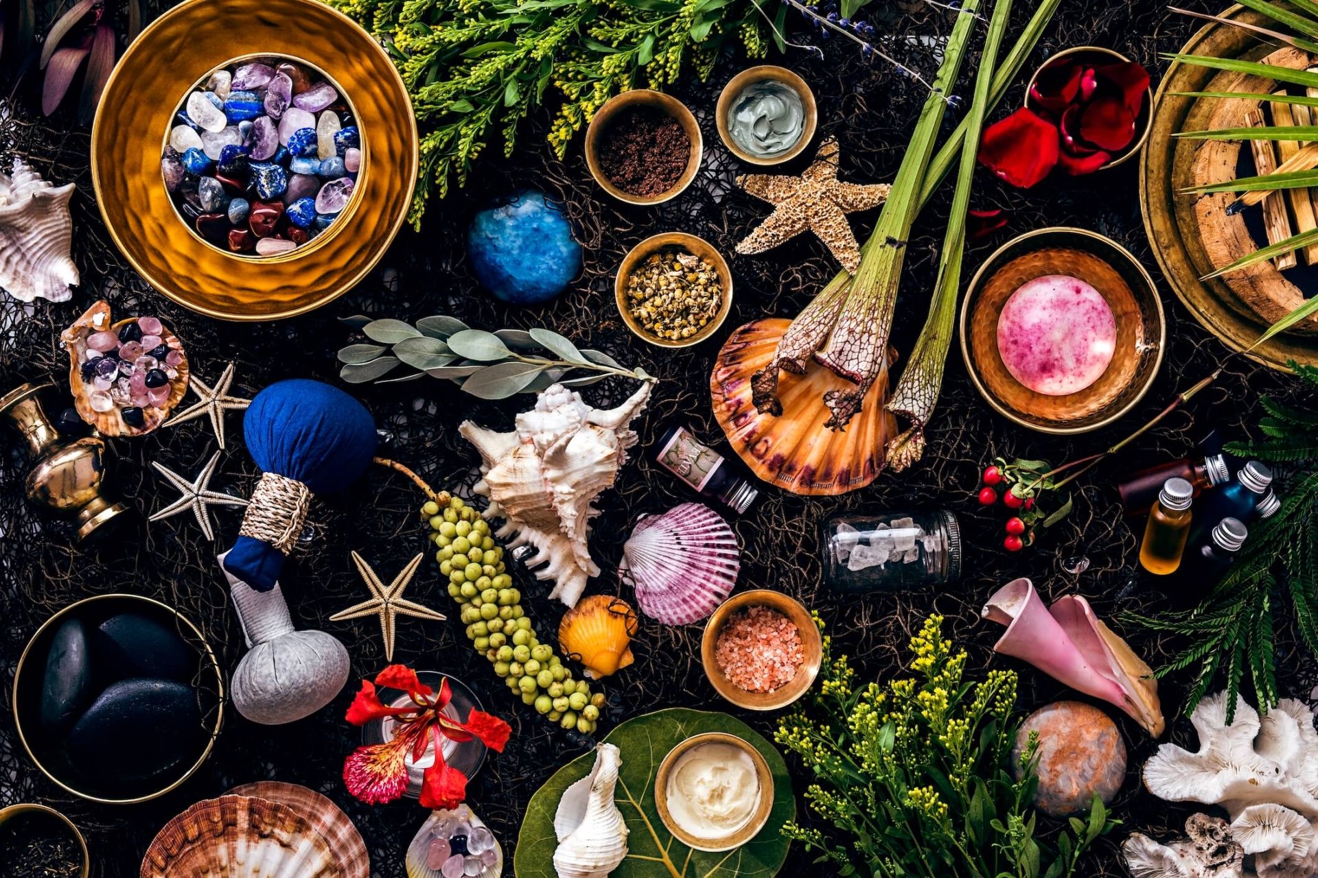 flat lay of starfish, shells, gems, and trinkets