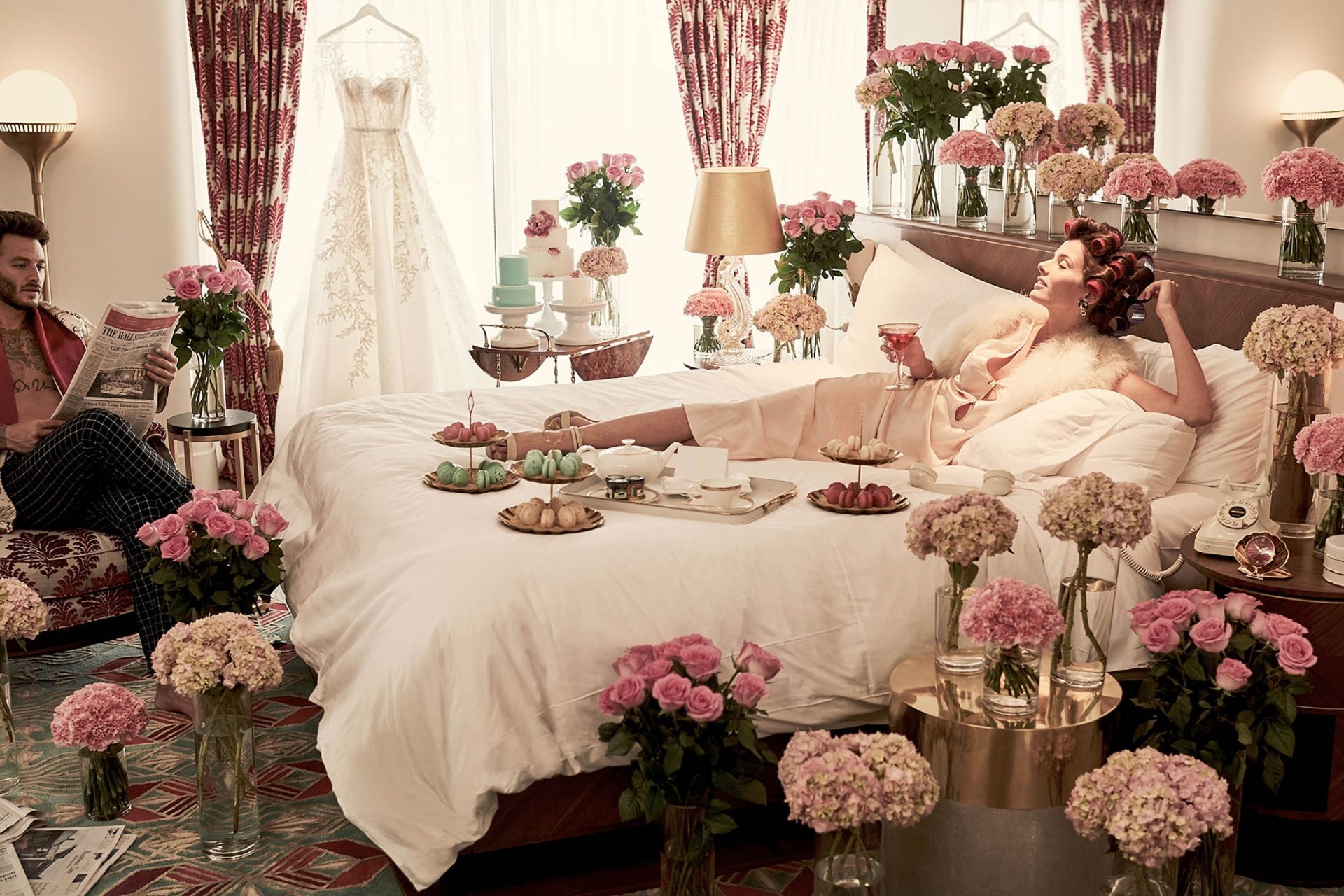 couple in bedroom on bed surrounding by flowers