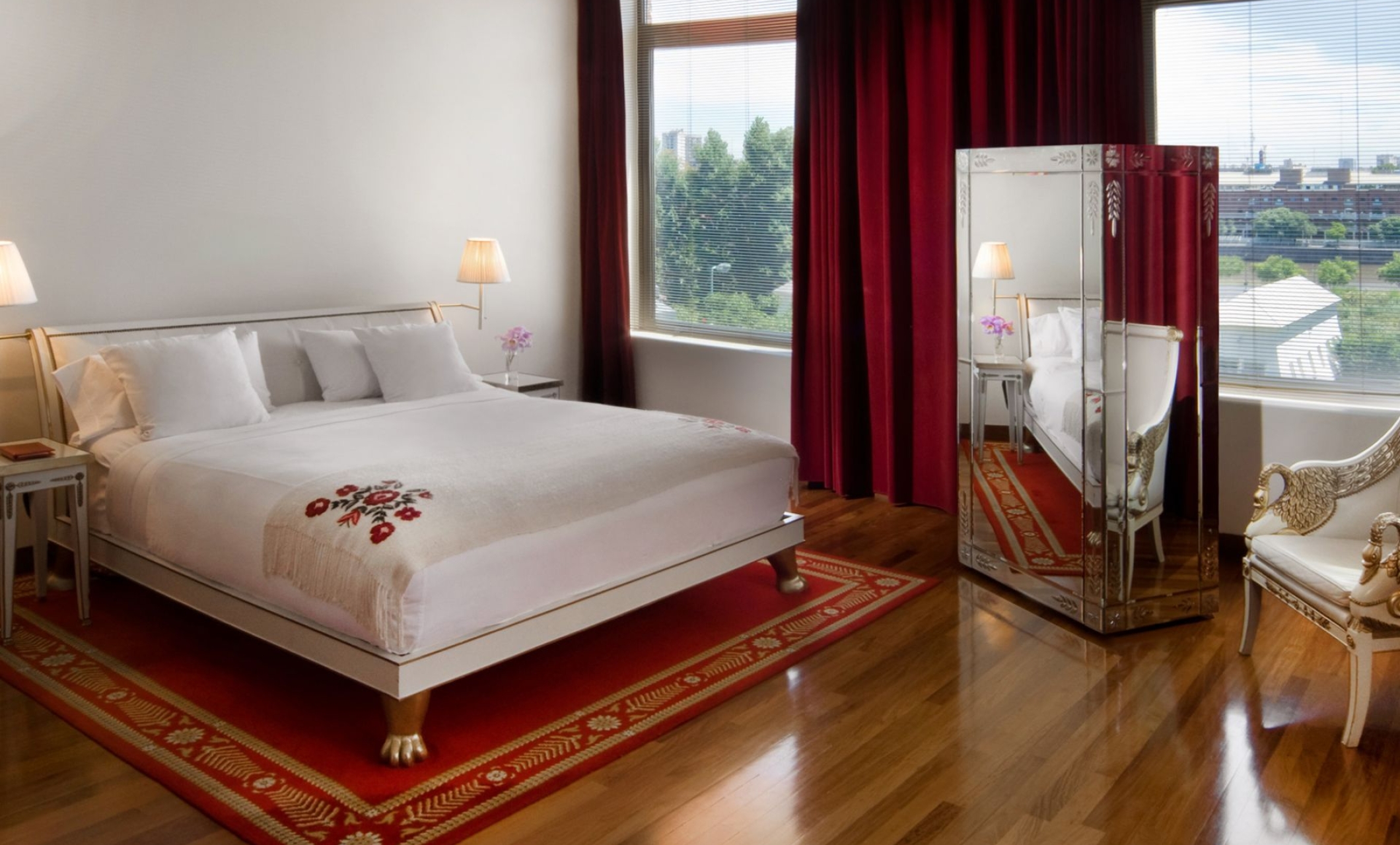 bed in hotel room with large windows