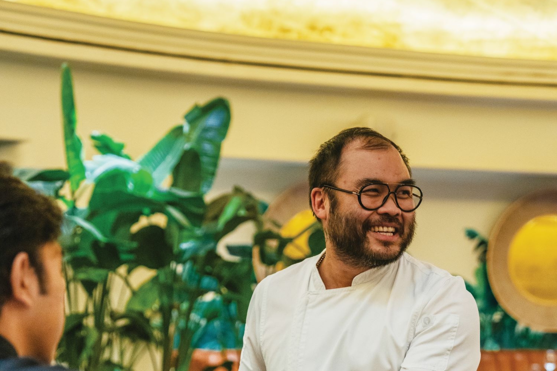 Paul Qui serving guests with a smile