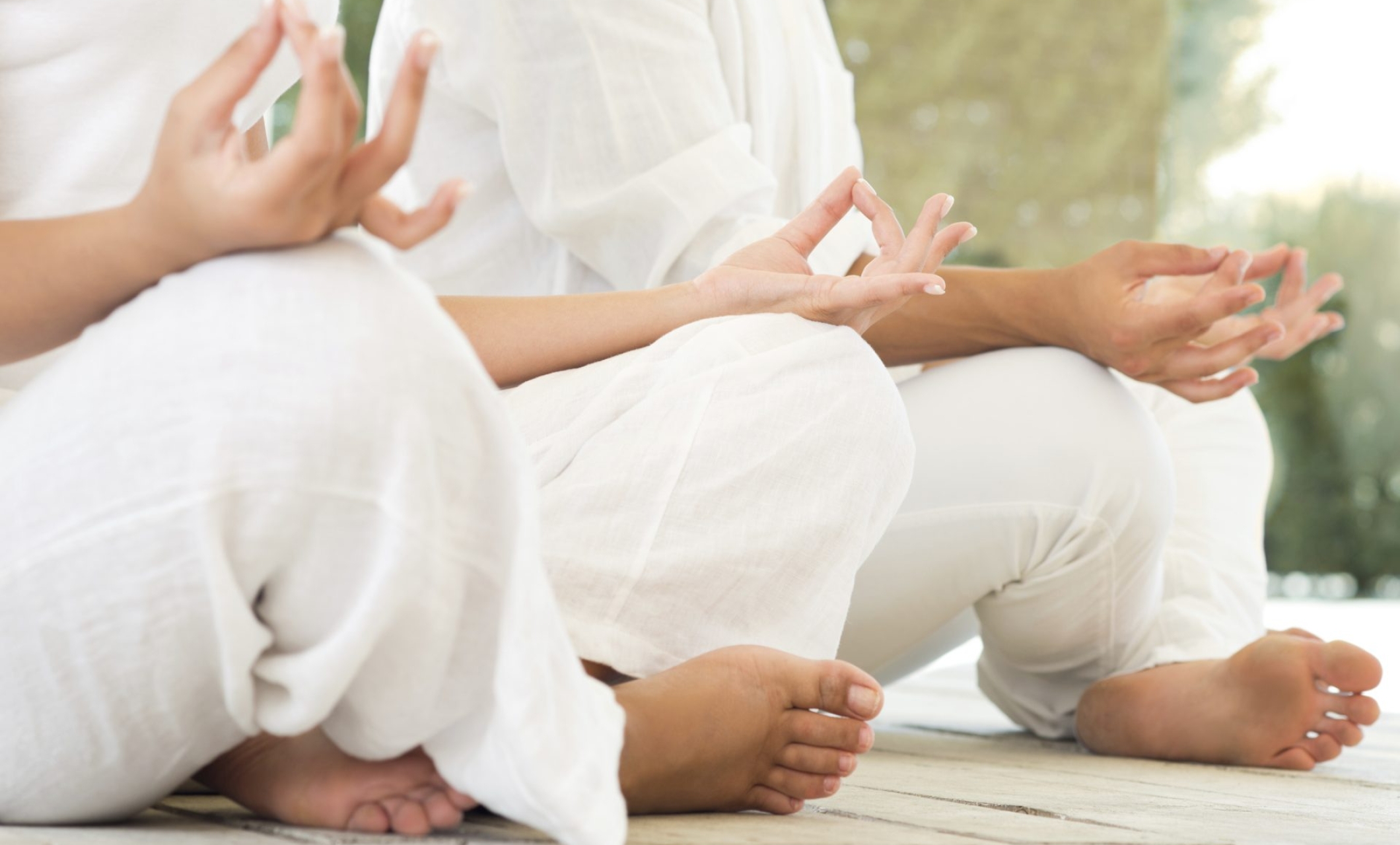 two people sitting in lotus position